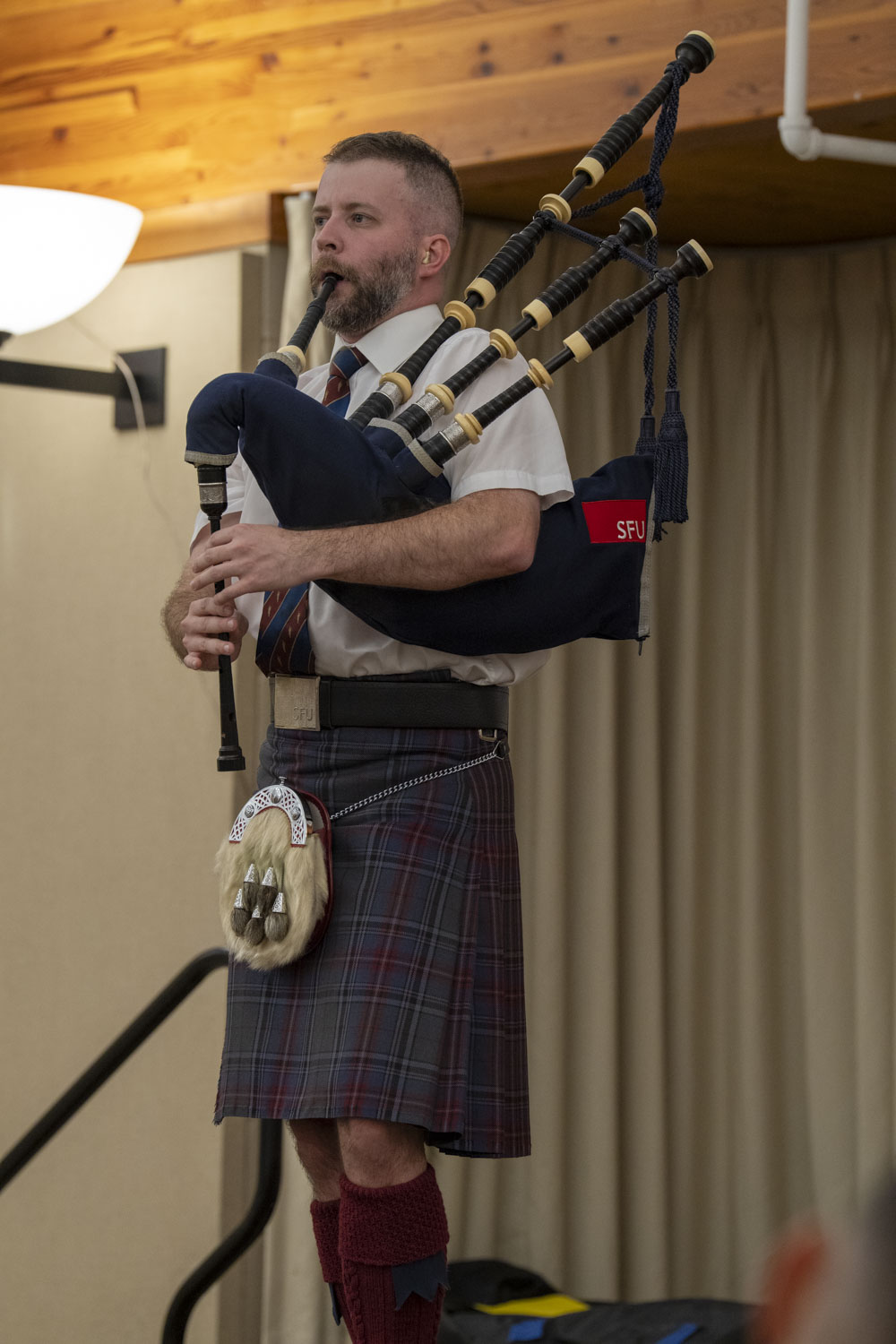 Alastair Lee playing Highland bagpipes at an event